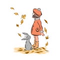 Little girl with rabbit under leaf fall